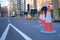 Roadwork cones on street with back of temporary traffic lights