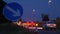 Roadworks cones flashing on UK motorway at night with traffic passing