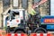 Roadworks. Workman operating heavy machinery on village street.