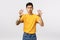 Roar hot staff. Cheeky and handsome stylish asian man in yellow t-shirt, making paw gesture as if squeezing something or