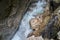 A roaring torrent with turquoise water and white foam between narrow rocks