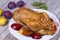 Roast duck with plums and apples.