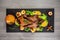 Roast duck stuffed with apples and orange sauce on a shale board. Festive dinner. delicious dish. top view. place for text