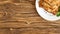 Roast meat in a plate on a wooden table. shot from above.