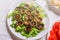 Roast mushrooms in white plate with green salad. Wedding table decoration in restaurant