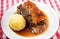 Roast pork shoulder with dumplings and dark beer sauce