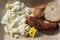 Roast sausage with potato salad, mustard and bread on a bamboo plate, fast food to go on a street festival, top view from above