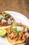 Roast tacos with corn tortillas. Mexican food. Mexican food concept on wooden table. Traditional Mexican food. Mexican tacos