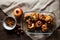 Roasted apples in a glass tray with chestnuts, candle, cinnamon, orange and pomegranate