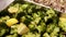 Roasted broccoli florets with lemon on baking tray, steam from the dish, food master class, selective focus