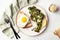 Roasted broccolini with fried egg on the plate