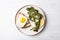 Roasted broccolini with fried egg on the plate.