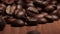 Roasted brown coffee beans sprinkling from top,  front view
