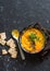 Roasted carrot and turmeric soup on a dark background