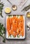 Roasted Carrots with thyme, garlic, lemon and honey on baking try , cooking preparation