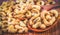 Roasted cashew nuts on a wooden spoon.Roasted salted cashew nuts on white background