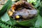 Roasted catfish in banana leaves vessel