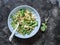 Roasted cauliflower, orzo pasta, arugula salad on a dark background, top view. Delicious vegetarian food concept