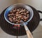 Roasted chestnuts in an iron pan cooked on the grill