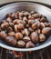 Roasted chestnuts in an iron pan cooked on the grill
