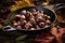 Roasted chestnuts in a pan on a wooden background