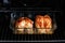 Roasted chicken breasts in a glass baking tray in oven