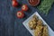 Roasted chicken drumsticks on a plate. Breaded chicken drumsticks, fried chicken. Dark wooden background