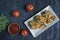 Roasted chicken drumsticks on a plate. Breaded chicken drumsticks, fried chicken. Dark wooden background