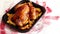 Roasted chicken or turkey with potatoes in black steel mold