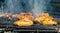 Roasted chicken wings on the hot grill; meat preparation process on the smoking grill