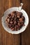 Roasted cocoa chocolate beans in old enamel sieve