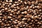 Roasted coffee beans backgound, copy space, top view. Cappuccino, dark espresso, aroma black caffeine drink, ingredient