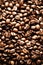 Roasted coffee beans backgound, copy space, top view. Cappuccino, dark espresso, aroma black caffeine drink, ingredient