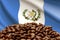 Roasted coffee beans on the background of the flag of Guatemala. Concept: best flavored coffee, export and import.