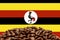 Roasted coffee beans on the background of the flag of Uganda. Concept: best flavored coffee, export and import.