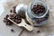 ROASTED COFFEE BEANS IN A GLASS JAR ON A TABLE TOP