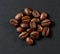 Roasted coffee beans group close-up on gray background