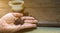 Roasted coffee beans on hand for espresso coffee mugs,black seed coffee on wooden floor background,coffee morning,selective focus