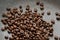 Roasted coffee beans on hot granit grey pan surface
