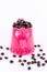 Roasted coffee beans in pink water can
