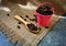 Roasted coffee beans in a pink zinc bucket on a sackcloth background.