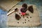 Roasted coffee beans in a pink zinc bucket on a sackcloth background.