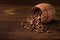 Roasted coffee beans in a wooden barrel