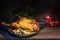 Roasted duck as Christmas menu with red cabbage and vegetables, a festive meal on a rustic wooden table with burning candle and