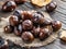 Roasted edible chestnut fruits on wooden table