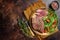 Roasted Flank or Flap Steak in a plate with salad. Dark background. Top view. Copy space