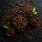 Roasted fragrant coffee beans on a black stone background. Top view. Free space for your text