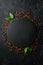 Roasted fragrant coffee beans on a black stone background. Top view. Free space for your text