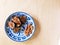 Roasted fresh figs and almonds on blue and white plate
