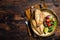 Roasted Gilthead Sea Bream fillets served with fresh vegetable salad. Wooden background. Top view. Copy space